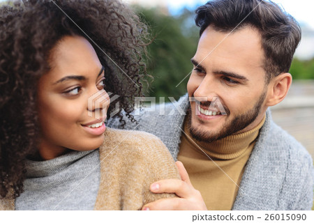 lovable couple standing outdoors 26015090