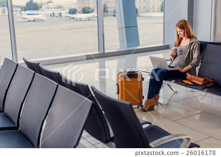 Stock Photo: Beautiful girl using laptop in airport