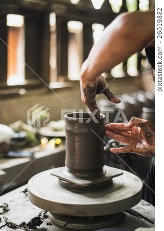 potter's hands to make an earthen pot 26019882