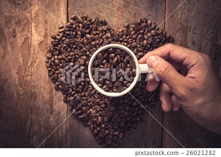 Man hand holding coffee cup and coffee bean Man hand holding coffee cup and coffee bean 26021282