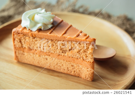 Thai tea layer cake on wood plate. Thai tea layer cake on wood plate. 26021541
