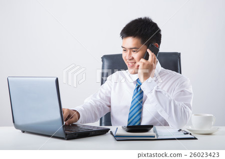 Portrait of businessman talking on mobile phone Portrait of businessman talking on mobile phone 26023423