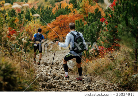 two haikers descend from mountain trail 26024915