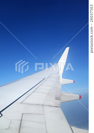 Wing of an airplane on blue sky 26037563
