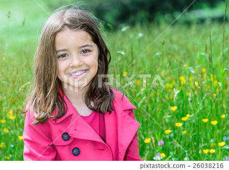 happy cute child sitting in a grass of a flower garden 26038216