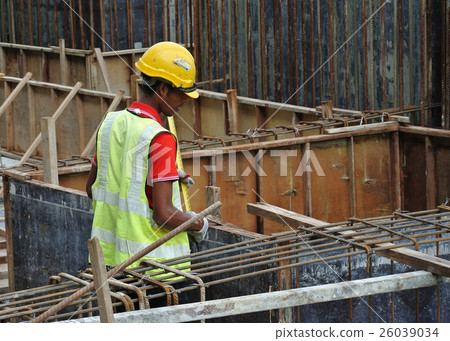 Construction workers fabricating timber form work  26039034