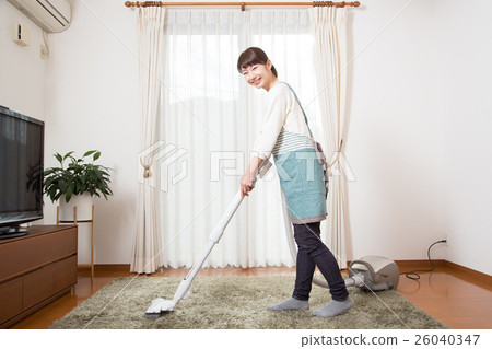 A young lady wearing a vacuum cleaner 26040347