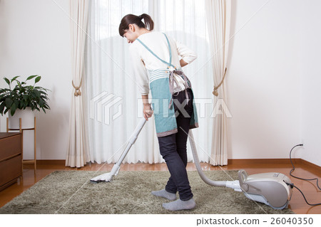 A young lady wearing a vacuum cleaner 26040350