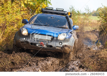 Japanese off-road car moving through deep mud Japanese off-road car moving through deep mud 26040433