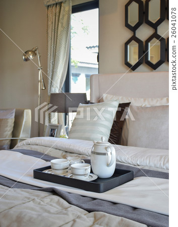 decorative tea cup set on black tray in bedroom 26041078