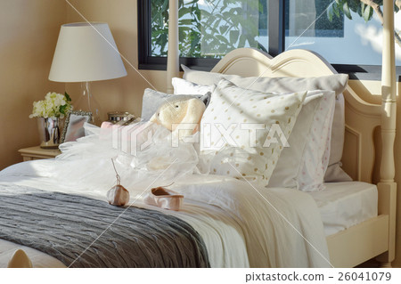 girl's bedroom with ballet shoes and dolls on bed girl's bedroom with ballet shoes and dolls on bed 26041079