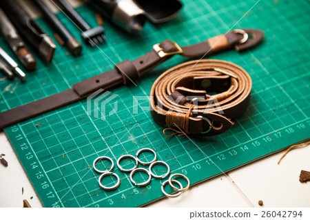Leather crafting tools on work table. 26042794