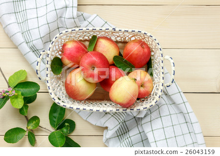 Top view red apple and leaf in basket on wooden. Top view red apple and leaf in basket on wooden. 26043159
