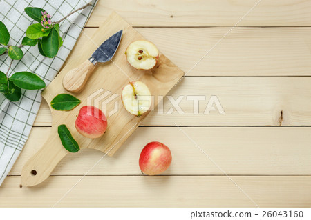 red apple sliced,knife,napkin, leaf on wooden. 26043160