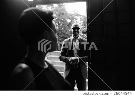 Man in the doorway, silhouette of a woman Man in the doorway, silhouette of a woman 26044544