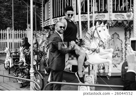 adult man and woman on a carousel adult man and woman on a carousel 26044552