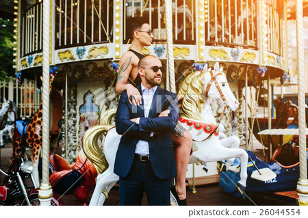 adult man and woman on a carousel adult man and woman on a carousel 26044554