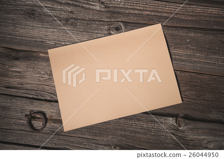 Paper sheet on old wooden background 26044950
