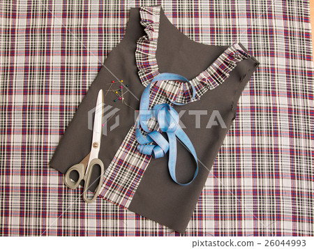 Top view of the workpiece and the children's school dress sewing supplies 26044993