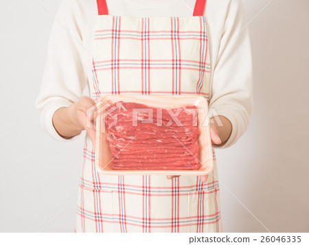 A woman with anxious face and meat 26046335