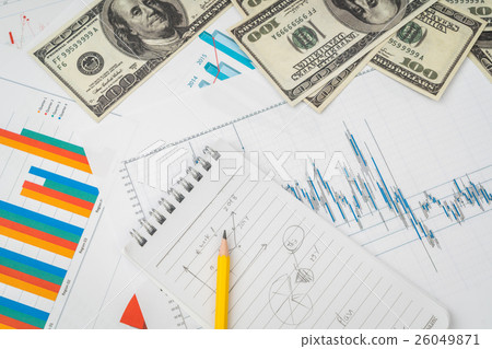 Financial charts on the table with dollars banknotes . 26049871