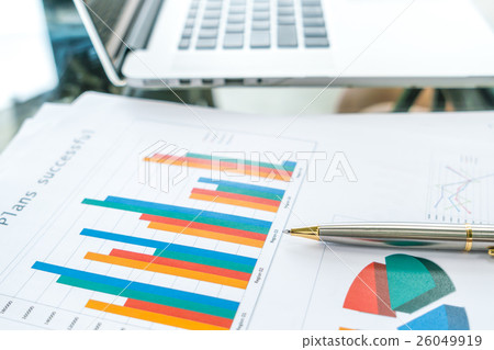 Financial charts on the table with laptop . Financial charts on the table with laptop . 26049919