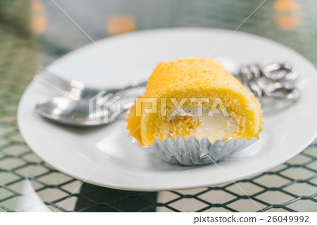 Cake roll butter cream on white plate . Cake roll butter cream on white plate . 26049992