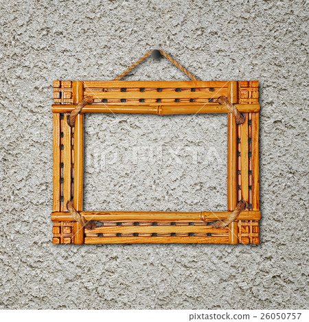 Bamboo frame on gray stucco concrete wall. Bamboo frame on gray stucco concrete wall. 26050757