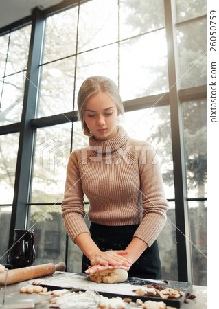Young woman knead dough at kitchen, bakery making Young woman knead dough at kitchen, bakery making 26050759