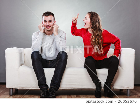 Angry fury woman screaming man closes his ears. Angry fury woman screaming man closes his ears. 26052676