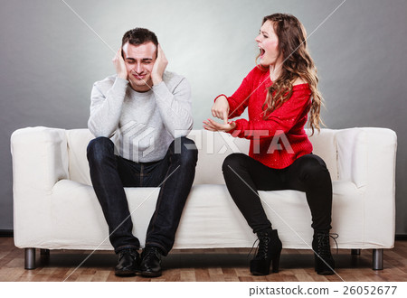 Angry fury woman screaming man closes his ears. Angry fury woman screaming man closes his ears. 26052677