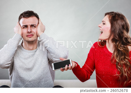 Wife shouting at husband. Cheating man. Betrayal. 26052678