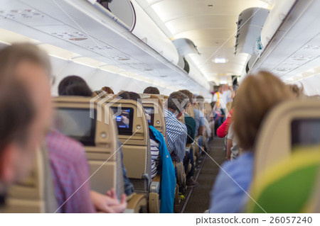 Interior of airplane with passengers on seats Interior of airplane with passengers on seats 26057240