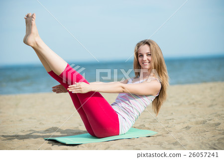 Young lady practicing yoga. Workout near ocean sea Young lady practicing yoga. Workout near ocean sea 26057241