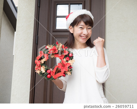A woman with a Christmas wreath A woman with a Christmas wreath 26059711
