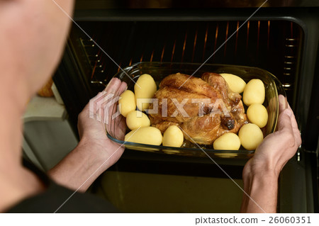 young man preparing a roast turkey 26060351