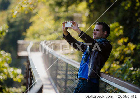 male traveler with smart phone taking a photo of male traveler with smart phone taking a photo of 26060491