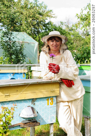 Portrait of a woman beekeeper with flower Portrait of a woman beekeeper with flower 26063297