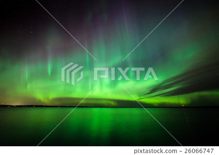 Northern lights over lake in finland 26066747