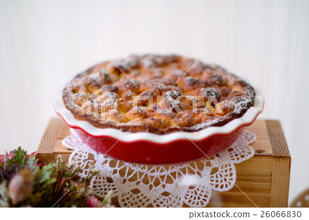 Table with sweet pie in red porcelain tray laid on 26066830