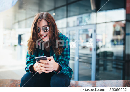 Portrait of urban fashionable girl using smart 26066932