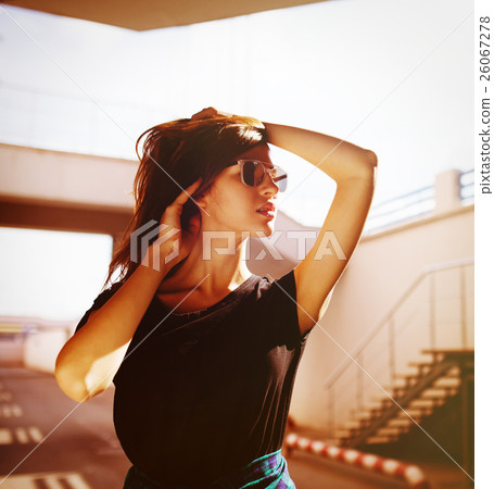 Urban fashionable girl posing outdoors in the city 26067278