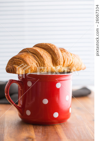 Tasty buttery croissant. 26067334
