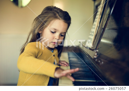 Adorable Cute Girl Playing Piano Concept Adorable Cute Girl Playing Piano Concept 26075057