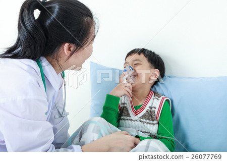 Boy having respiratory illness helped by doctor. Boy having respiratory illness helped by doctor. 26077769