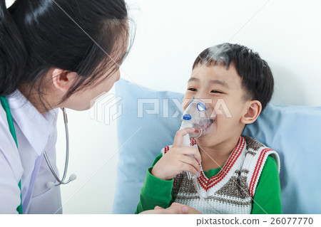 Boy having respiratory illness helped by doctor. Boy having respiratory illness helped by doctor. 26077770