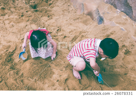 Top view. Happy brother and sister play with sand. 26078331