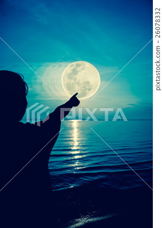 Silhouette of woman pointing to the full moon Silhouette of woman pointing to the full moon 26078332