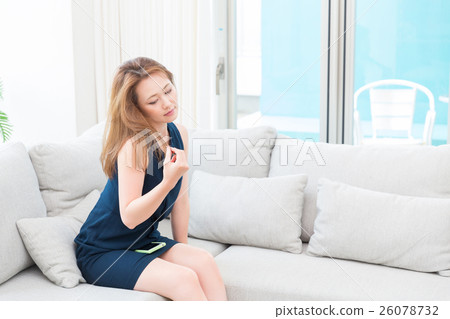 A woman touching her hair A woman touching her hair 26078732