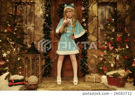 Snow Maiden on doorstep of house decorated in Christmas style 26083732